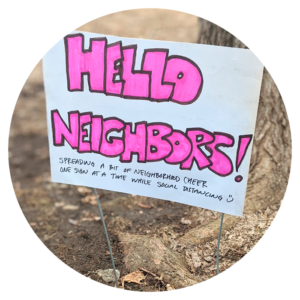 A photo of a sign outside that says "Hello Neighboors"
