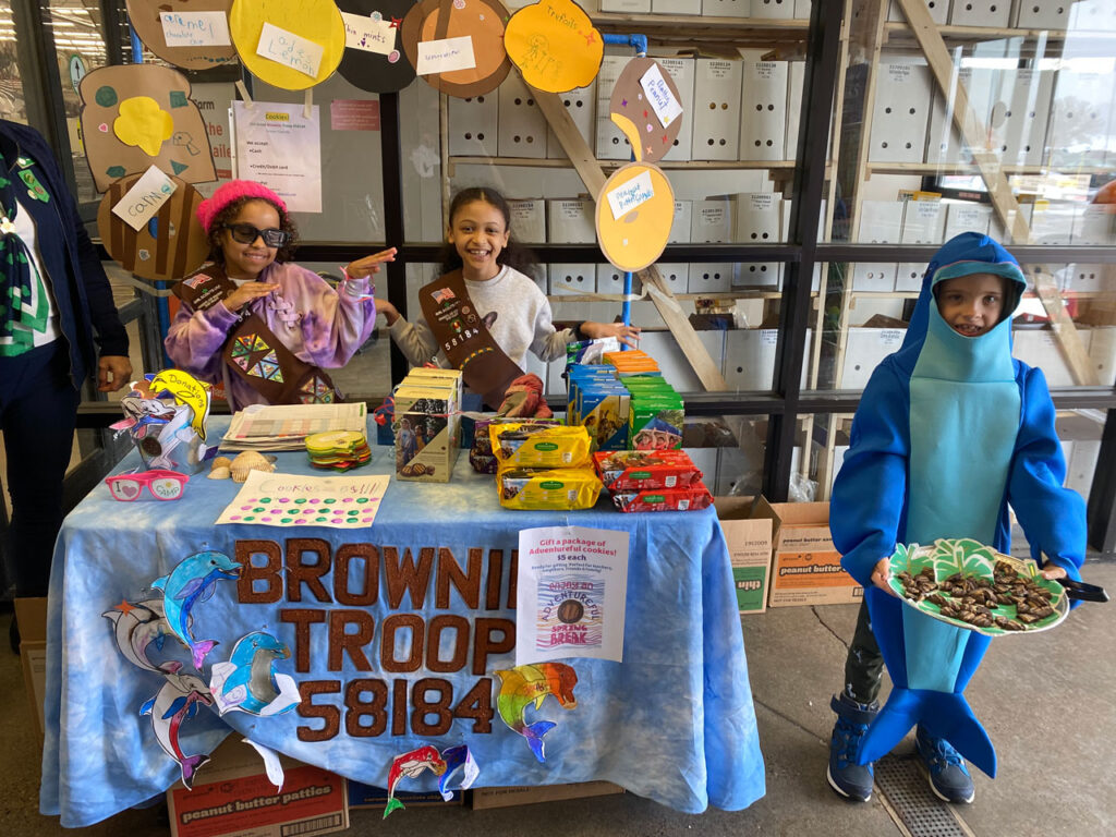Girl Scouts managing their cookie booth