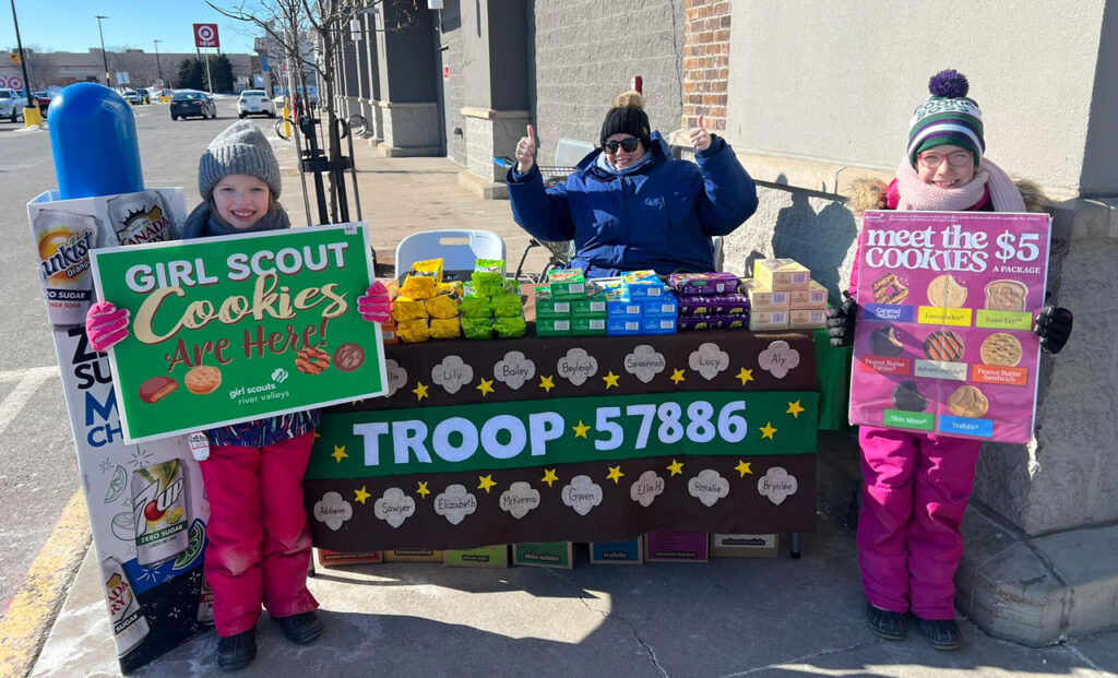 Girl Scouts managing their cookie booth